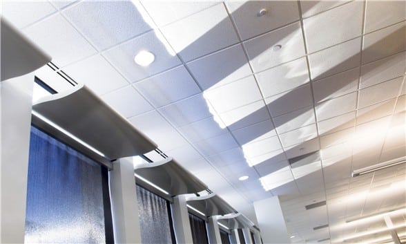 Light Shelf installed over roller shades in an office